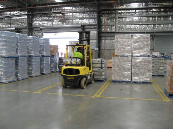 Forklift moving palletised stock inside a warehouse